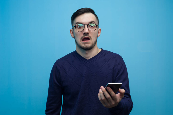 Portrait of an emotional young man in glasses - Fotó, kép