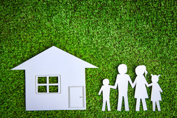 Paper family with a house on a background of grass - Photo, Image