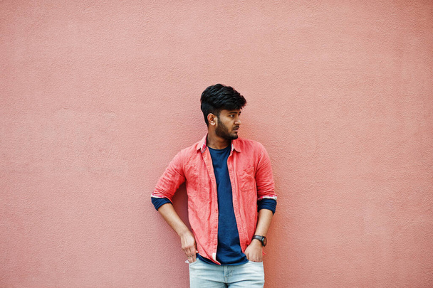 Portrait of young stylish indian man model isolated on pink wall background. - Photo, image