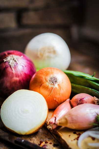 Colorful onions and garlic on rustic wooden background - Фото, зображення