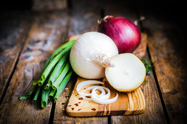 Colorful onions and garlic on rustic wooden background - Foto, immagini