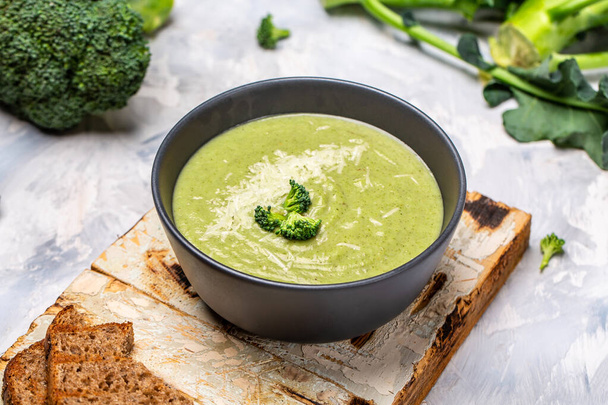 Green vegetable cream soup, with broccoli and parmesan, Clean eating, dieting, vegan, vegetarian, healthy food concept, top view. - Φωτογραφία, εικόνα