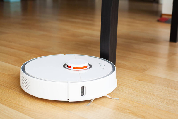 Robot vacuum cleaner performs automatic cleaning of the apartment at a certain time. Smart home. - Photo, Image