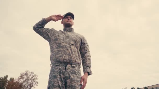 Low angle view of soldier saluting with sky at background outdoors  - Footage, Video