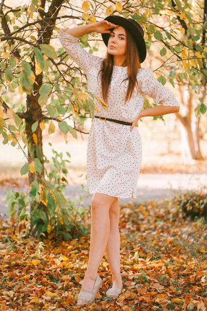 Girl walks in a dress and hat in the park. - Foto, imagen