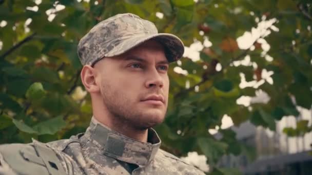Young soldier in military uniform saluting outdoors  - Footage, Video