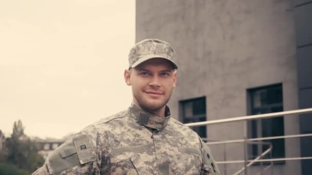 Smiling soldier in uniform greeting while walking outdoors  - Footage, Video