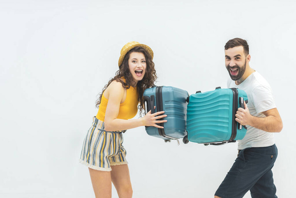 Photo where man and woman holding big suitcases for travelling. - Фото, зображення