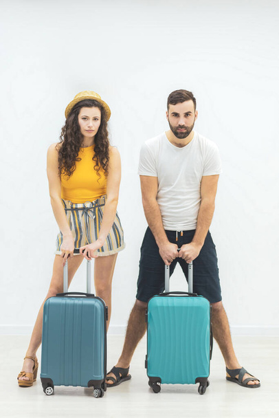 Concept of vacation photo. Beautiful young loving couple with passports and hat leaving. - Foto, afbeelding