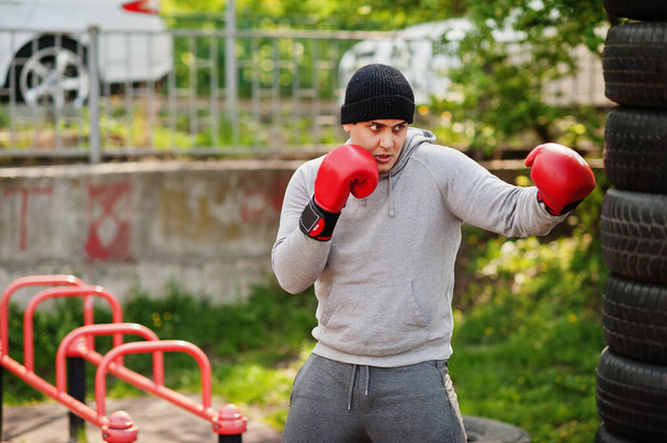 Man arabian boxer in hat training for a hard fight outdoor gym - Foto, Imagem