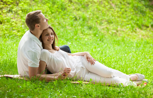 Loving couple having time together in a green meadow - Фото, зображення