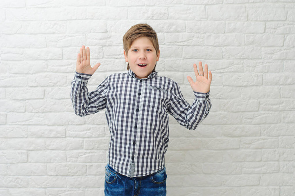 Happy boy making dab arms gesture on white studio background, funny guy dabbing moving in internet meme pose celebrating victory having fun, dance school or triumph concept - Foto, afbeelding