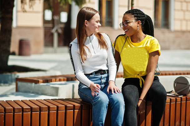 White caucasian girl and black African American together. World unity, racial love, understanding in tolerance and races diversity cooperation. - Valokuva, kuva
