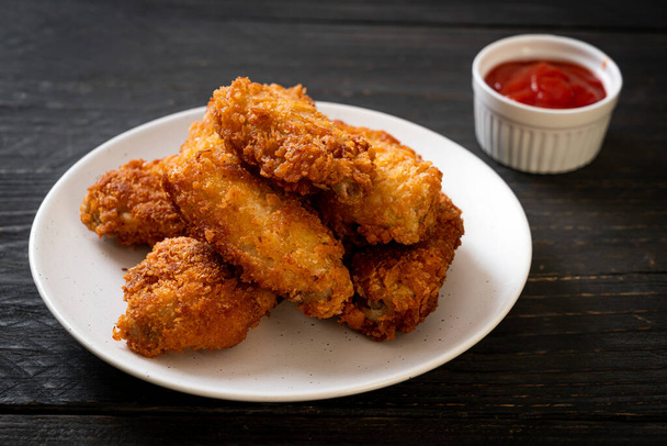 fried chicken wings with ketchup - unhealthy food - 写真・画像