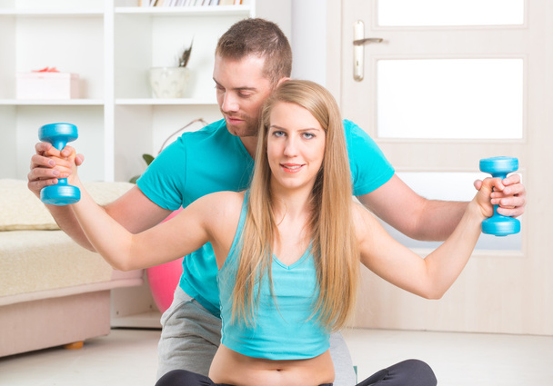 Woman with personal trainer at home - Photo, Image