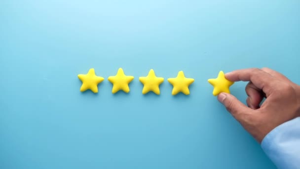 Customer review concept. Rating golden stars on blue background  - Footage, Video