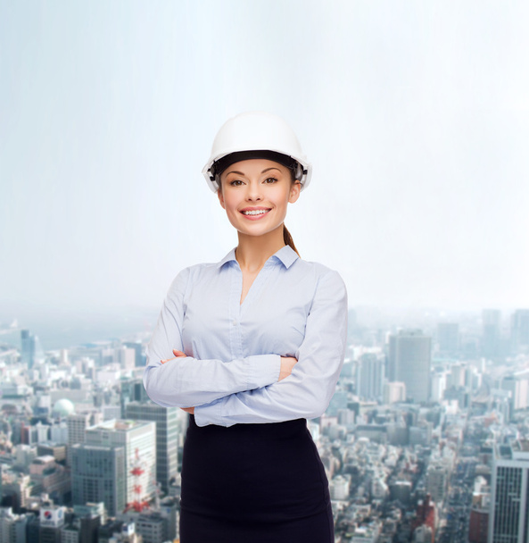 Friendly smiling businesswoman in white helmet - Zdjęcie, obraz