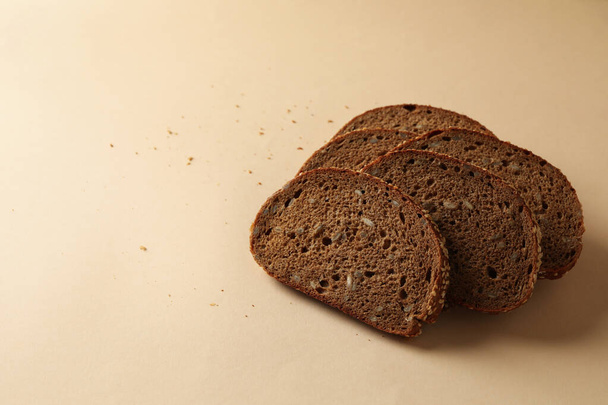 Verse gebakken roggebrood plakjes op beige achtergrond - Foto, afbeelding
