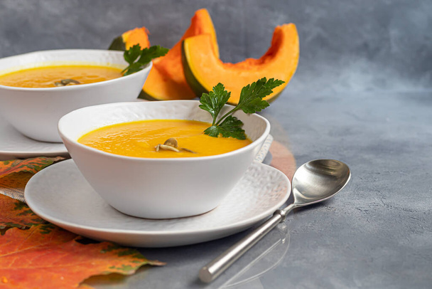 Fresh pumpkin cream soup with sour cream. Autumn lunch concept. A dietary, healthy dish. Copy space. - Photo, Image