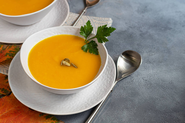 Fresh pumpkin cream soup with sour cream. Autumn lunch concept. A dietary, healthy dish. Copy space. - Photo, Image