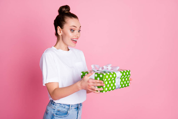 Turned photo of astonished positive girl get incredible big green dotted gift box impressed wear good look outfit isolated over pastel color background - Valokuva, kuva