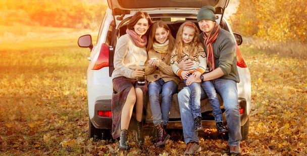 Family sitting in car trunk - Valokuva, kuva