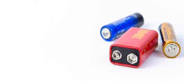three different color batteries on a white background.copyspace for text. - 写真・画像