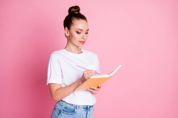 Photo of focused girl write copy book homework project wear good look clothes isolated over pink color background - Foto, immagini