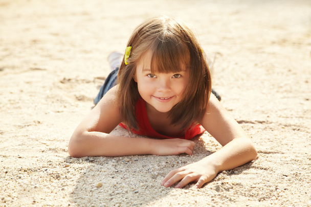 Girl lying on the sand - Фото, зображення