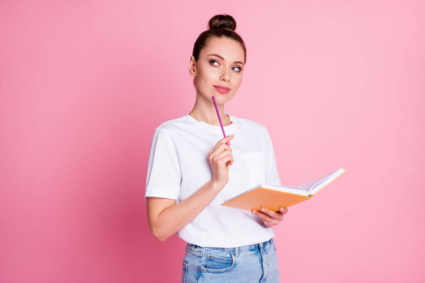 Photo of curious smart girl write copybook touch chin pencil look copyspace think thoughts decide project decision wear white t-shirt denim isolated over pastel color background - Zdjęcie, obraz