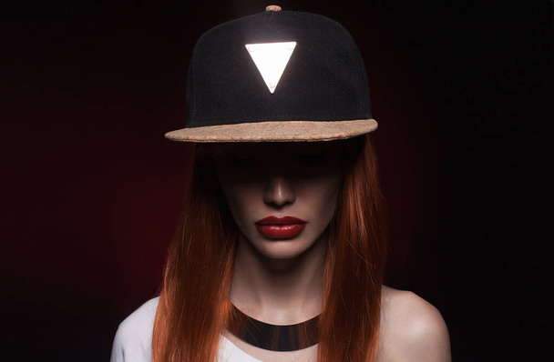 Beautiful red hair and red lips woman in hat. modern hip-hop dancer girl with make-up - Fotoğraf, Görsel