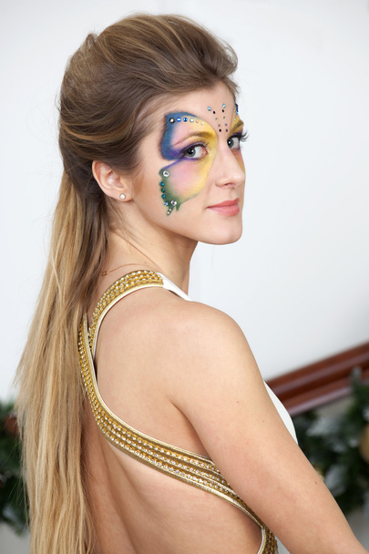 Portrait of beautiful girl with body art butterfly on her face - Фото, зображення