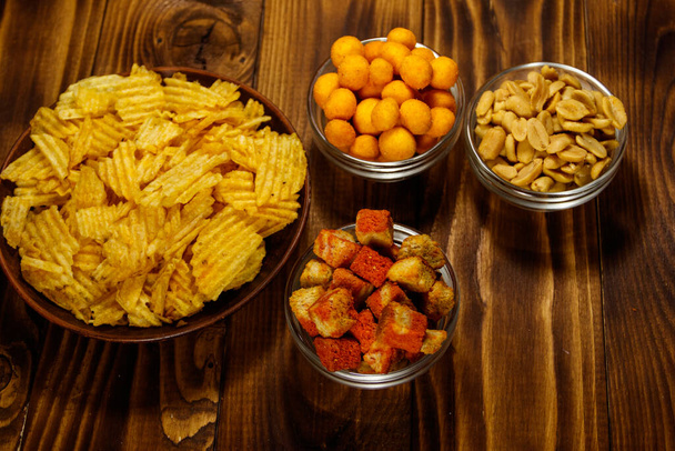 Mix of snacks for beer on wooden table - Photo, Image