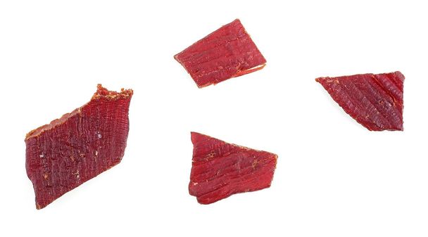 Portion of beef jerky isolated on a white background. Beef jerky pieces. - Foto, immagini