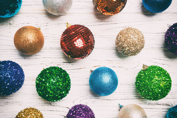 Top view of colorful Christmas balls on wooden background. New Year time concept. - Foto, immagini