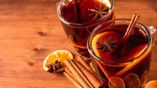 German tradition winter Christmas market new year holidays festival drink Gluhwein Mulled sweet hot warm red Wine with spices citrus aromatic cinnamon star anise - Фото, изображение