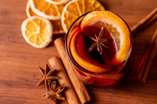 German tradition winter Christmas market new year holidays festival drink Gluhwein Mulled sweet hot warm red Wine with spices citrus aromatic cinnamon star anise - Photo, Image