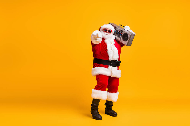 You prepare 2021 newyear. Full length photo of santa claus hold boom box point index finger on christmas x-mas disco wear headwear cap isolated bright shine color background - 写真・画像