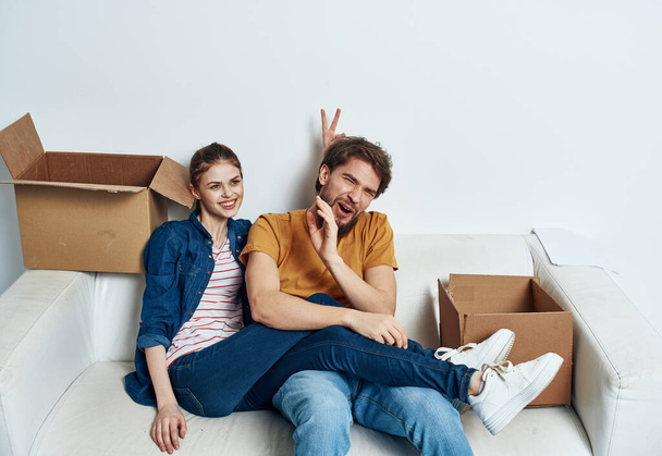 Man and woman in a new apartment boxes with things interior - Photo, Image