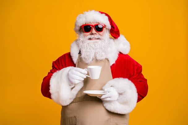 Close-up portrait of his he nice attractive cheerful cheery confident Santa shop owner drinking latte beverage cappuccino isolated bright vivid shine vibrant yellow color background - Foto, Imagen