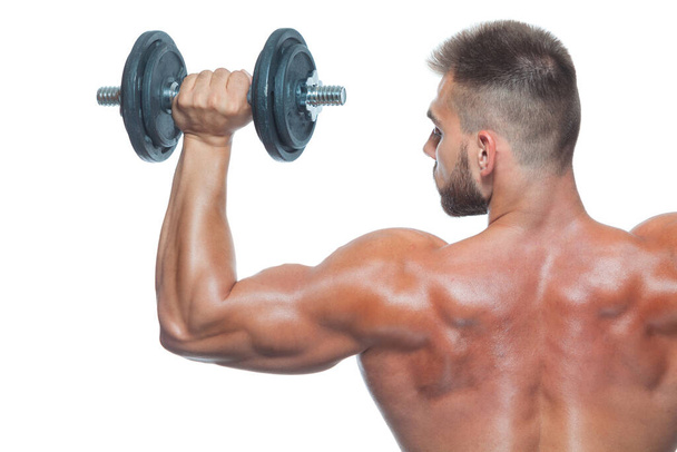 Close up back view on bodybuilders strong muscular arm lifting a dumbbell isolated on white background - Fotoğraf, Görsel