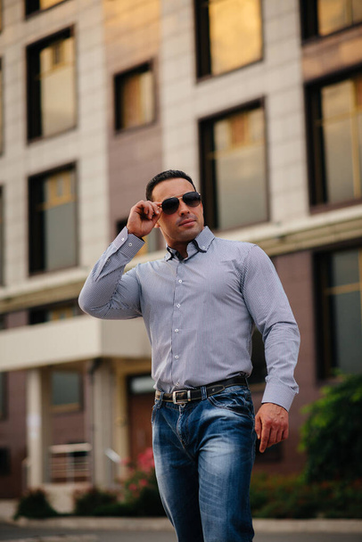 Young successful man near an office building. Business - Zdjęcie, obraz