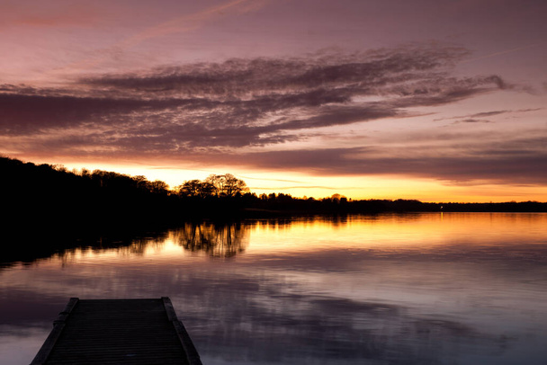 Sunset in Sjaelsoe lake in Rudersdal in Denmark - Фото, изображение