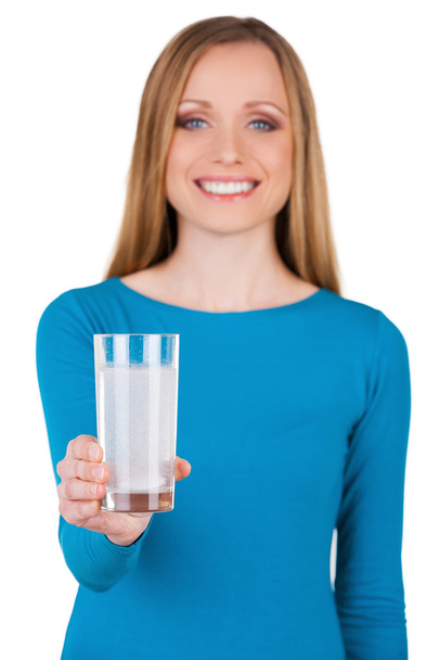 Woman holding a glass with water and aspirin in it - Фото, изображение
