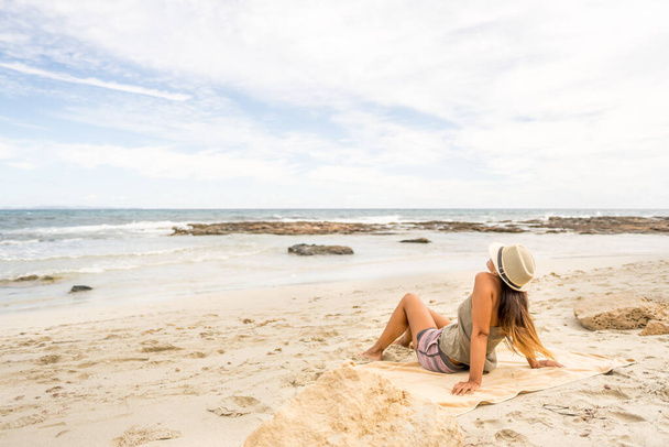 Pretty woman sunbathing on the beach. Long shot. Formentera island, Spain. - Valokuva, kuva