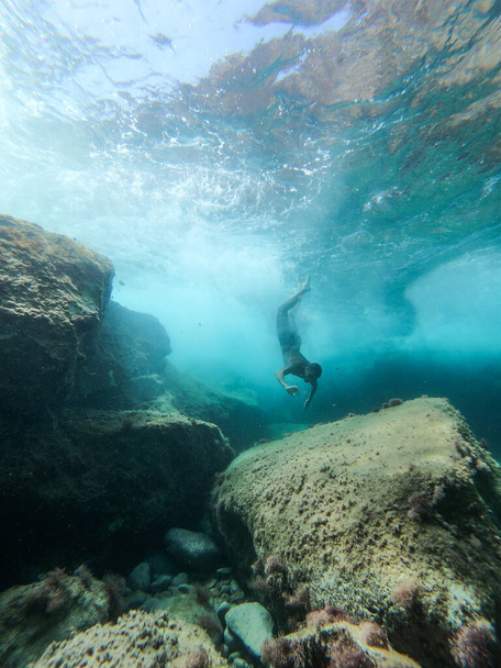 Man diving into the sea. View from inside the water. - Photo, Image