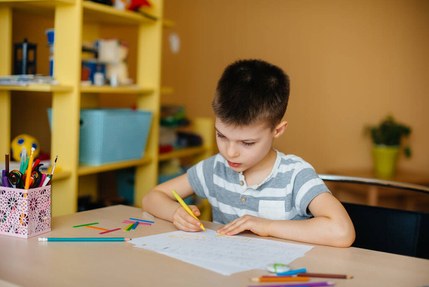 A school-age boy does homework at home. Training at school - Fotó, kép