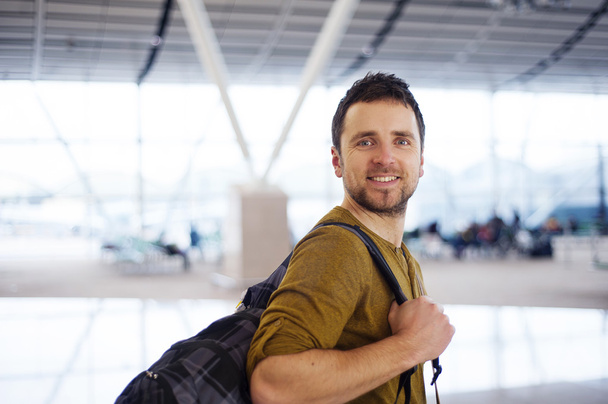 Happy man at the airport is going for holiday - Foto, imagen