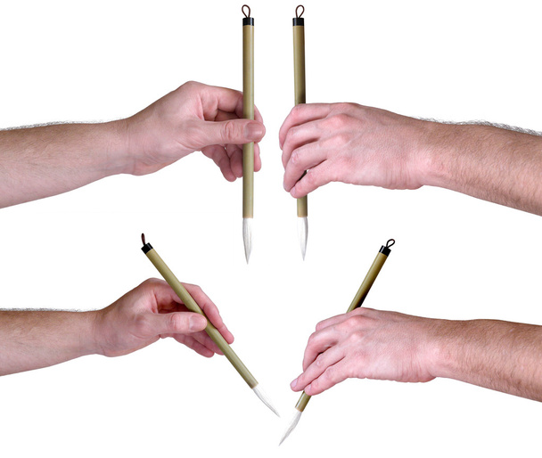 Mãos com escova caligráfica japonesa
 - Foto, Imagem