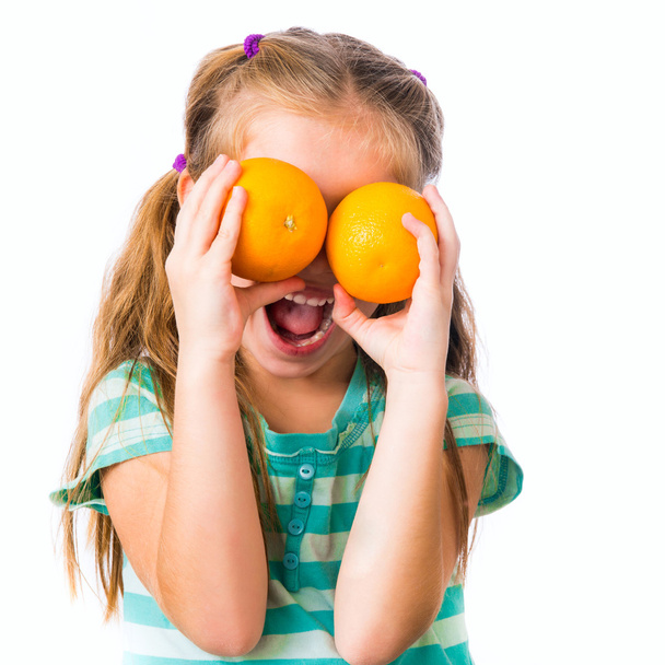 little girl with oranges - Foto, immagini